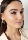 Earrings twisted leaves gold stainless steel thumbnail